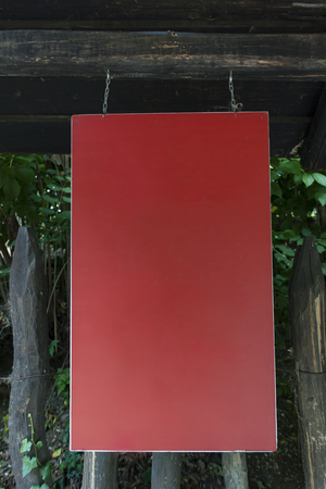 View of the empty signboard hanging from the plankの写真素材
