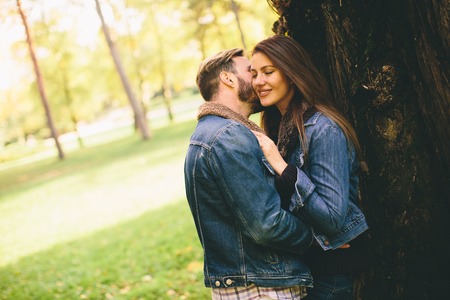 Loving couple in the autumn parkの写真素材