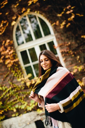 Young woman posing outside in autumn dayの写真素材