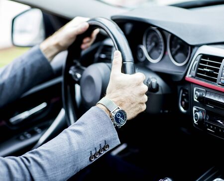 Young businessman driving car