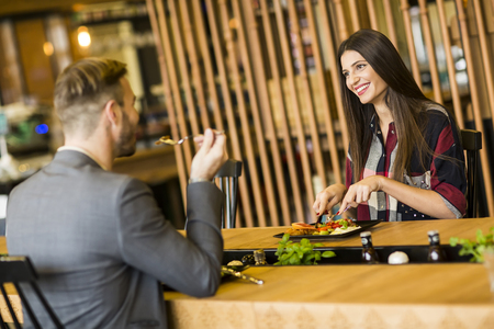 Young loving couple having lunch in the modern restaurantの写真素材