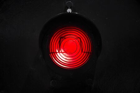 Red traffic light isolated on black backgroundの写真素材