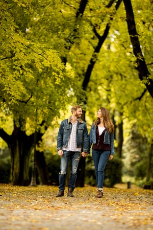Young loving couple having a walk in the autumn park