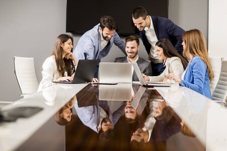 Young colleagues sitting at business meeting in the modern officeの写真素材