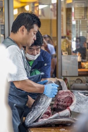 TOKYO, JAPAN - OCTOBER 2, 2016: Unidentified people at Tsukiji fish market in Tokyo, Japan. Tsukiji is the biggest wholesale fish and seafood market in the world.のeditorial素材