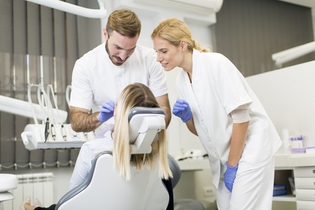 Young woman getting dental treatment in dentist officeの写真素材