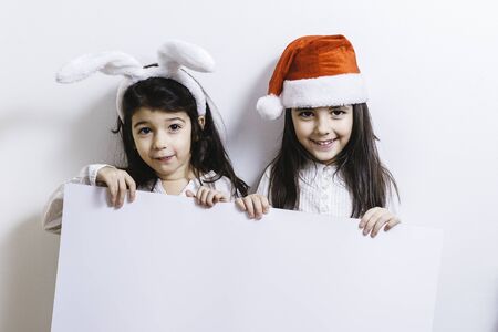 Two girls posing for Christmas and New Year holidaysの写真素材
