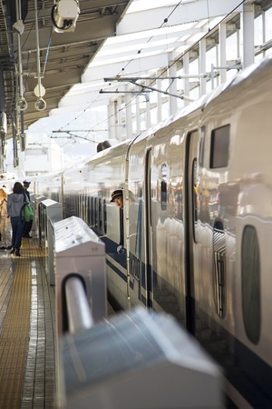 HIROSHIMA, JAPAN - OCTOBER 10, 2016: Unidentified womn at Shinkansen N700 speed train at Hiroshima station in Japan. N700 series trains have a maximum speed of 300 km/h.のeditorial素材