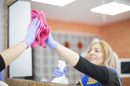 Woman at work, professional maid cleaning in dental officeの写真素材