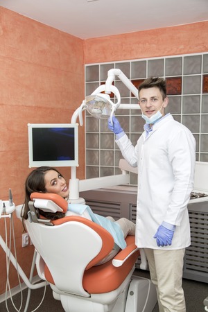 Young woman getting dental treatment in dentist officeの写真素材