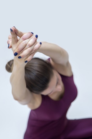 View at young woman practicing yoga in the studioの写真素材