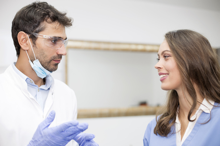 Young male and female doctors posing in the dentist officeの写真素材
