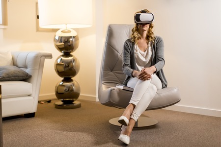 Woman wearing virtual reality goggles in the room