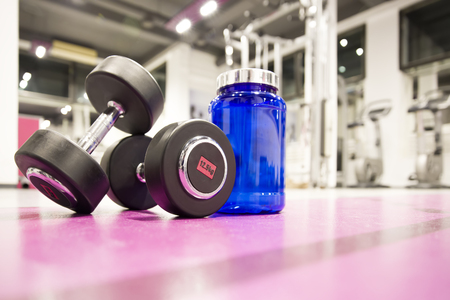 Weight and whey protein supplement in the gymの写真素材