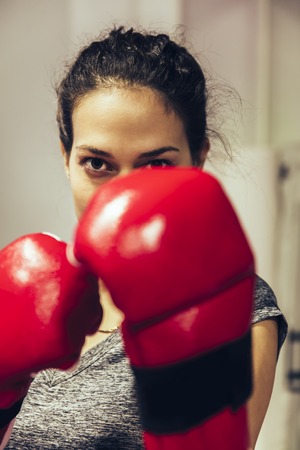Young woman practicing boxing in the gym