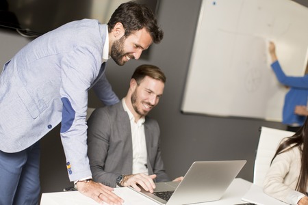 Young successful managers discussing new business project in modern officeの写真素材