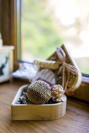 Wooden decorations in a box on windowの写真素材