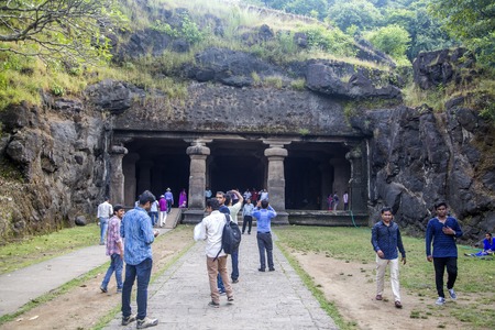 MUMBAI, INDIA - OCTOBER 11, 2015: Unidentified people on Elephanta island. It's popular tourist destination because of the island's cave temples. The toy train leads from the boat area on the dock to the base of the steps to the caves.のeditorial素材