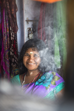 VARKALA, INDIA - OCTOBER 18, 2015: Unidentified woman at backwaters in Kerala, India. The backwaters are an extensive network of 41 west flowing interlocking rivers, lakes and canals that center around Alleppey, Kumarakom and Punnamada.のeditorial素材