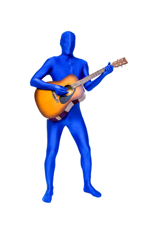 Mysterious blue man in morphsuit playing an acoustic guitar isolated on whiteの写真素材