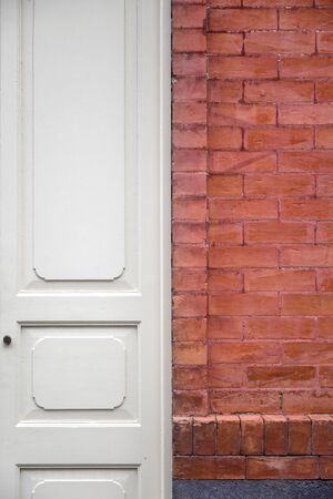White entrance door with the brickwall facadeの写真素材