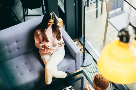 Top view of the woman sitting in the cafe with the tabletの写真素材