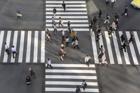 TOKYO, JAPAN- OCTOBER 12, 2016:  Unidentified people crossing the busy street in Ginza, Tokyo.It is a popular upscale shopping area of Tokyo.のeditorial素材