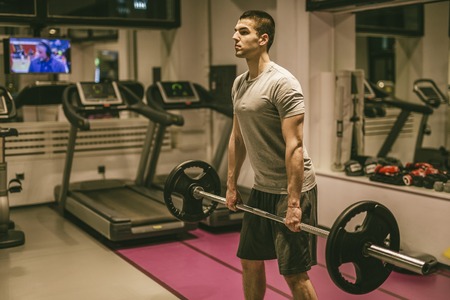 Strong man working out at gym fitness clubの写真素材