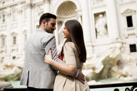 Tourist couple on travel by Trevi Fountain in Rome, Italy.の写真素材