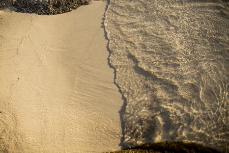 Close up of soft wave of sea on sandy beachの写真素材
