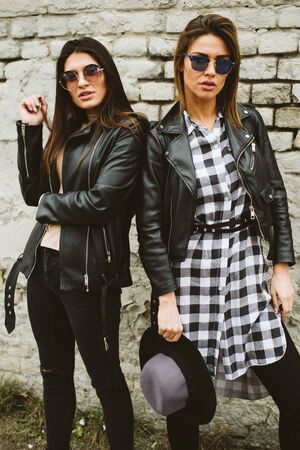 Two pretty young women with sunglasses outdoorsの写真素材