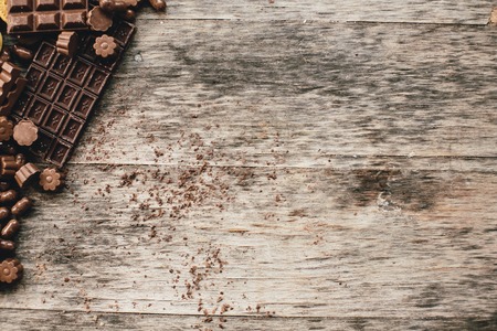 Chocolate and praline on a wooden baseの写真素材