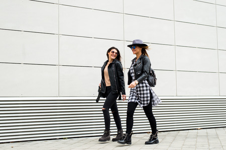 Two young modern girls on the streetの写真素材