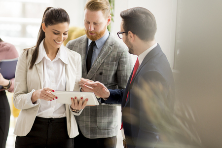 Group of businesspeople standing in the modern officeの写真素材