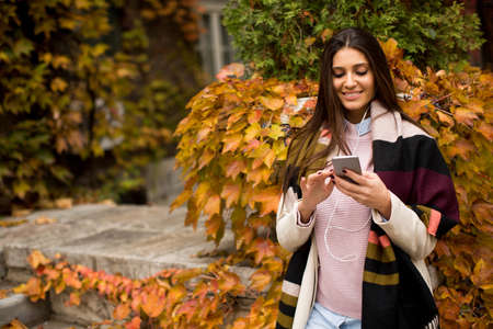 View at pretty young woman outdoor with mobile phoneの写真素材