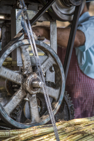 Detail of sugarcane juice making on street of Mumbai, Indiaの写真素材
