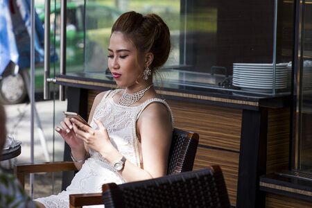 HUE, VIETNAM - FEBRUARY 19, 2017: Unidentified woman with mobile phone from Hue, Vietnam. In Vietnam, on 90 million people there are 130 million mobile phones.のeditorial素材