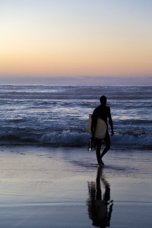 CASABLANCA, MOROCCO - SEPTEMBER 10, 2014: Unidentified surfer on the beach at Casablanca, Morocco. Casablanca offers several surf spots in the city area.のeditorial素材