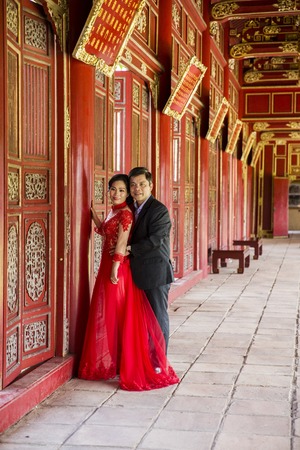 HUE, VIETNAM - FEBRUARY 19, 2017: Unidentified wedding couple at Royal Palace in Hue, Vietnam. Traditional Vietnamese wedding is one of the most important ceremonies in Vietnamese cultureのeditorial素材