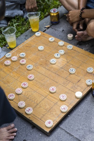 HO CHI MINH, VIETNAM - FEBRUARY 22, 2017: Unidentified man playing traditional Chinese chess on Ho Chi Minh sidewalk in Vietnam. It is one of the most popular board games in China.のeditorial素材