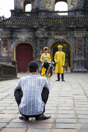 HUE, VIETNAM - FEBRUARY 19, 2017: Unidentified wedding couple at Royal Palace in Hue, Vietnam. Traditional Vietnamese wedding is one of the most important ceremonies in Vietnamese cultureのeditorial素材