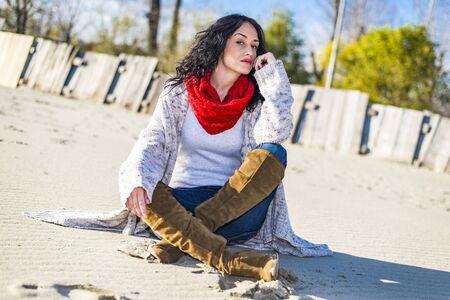 Cute young woman at the beach at winterの写真素材