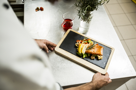 View at chef serving food in restaurantの写真素材