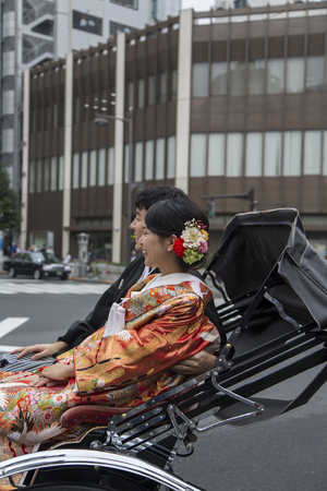 TOKYO, JAPAN - OCTOBER 3, 2016: Unidentified people riding on rickshaw at Asakusa district in Tokyo, Japan. Rickshaws are believed to have been invented in Japan in the 1860sのeditorial素材