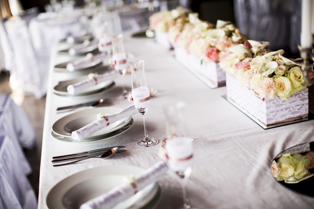 View at exquisitely decorated wedding table with bouquet of rosesの写真素材