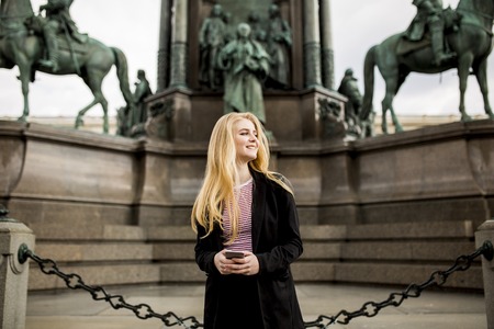 Young woman with mobile phone on the street of Vienna, Austriaのeditorial素材