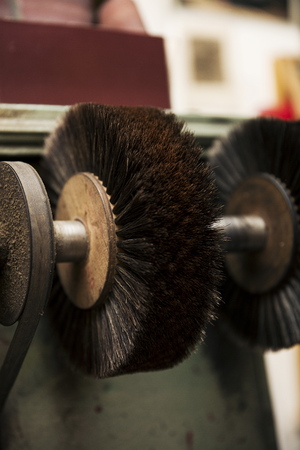 Rotating brush at shoe polisher in the shoemaker workshopの写真素材