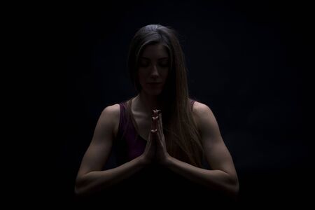 Young woman practicing yoga in the studio