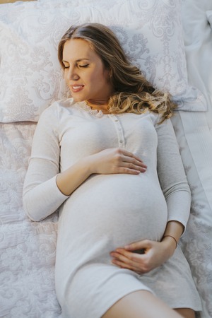 View at Pregnant woman on bed