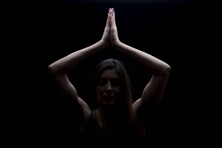 Young woman practicing yoga in the studioの写真素材
